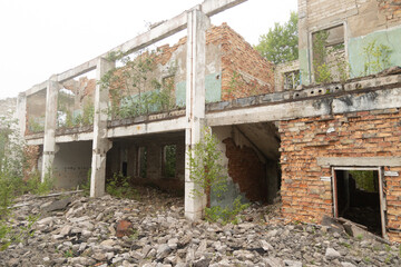 An old, collapsed building of Soviet army base in Latvia, Europe. Red brick wall of abandoned house.