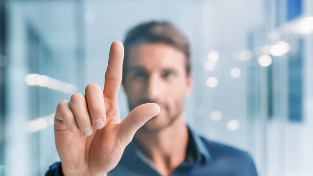 Business man pointing directly at the screen, interacting or selecting on the touchscreen technology digital presentation.