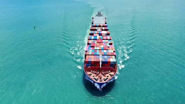 Front of Cargo container ship carrying container and running out international container port customs shipyard sea port concept smart logistic service.