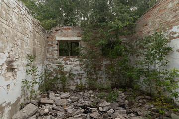 An old, collapsed building in soviet army base in Latvia, Europe. Abandoned white brick building.