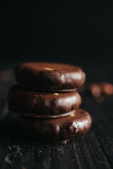 A dessert made of chocolate, dried fruits and coconut cream at dark background