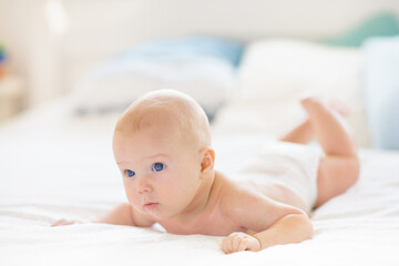 Little baby on white bed