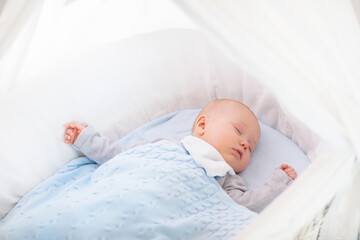 Little baby on white bed