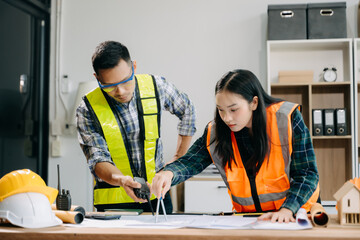 Engineer teams meeting working together wear worker helmets hardhat with on architectural project...