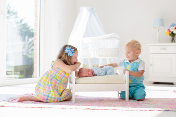 Kids play with newborn baby brother