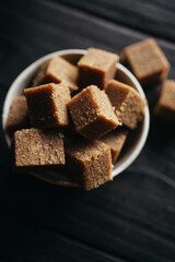 A still life of Halva in a bowl at dark background