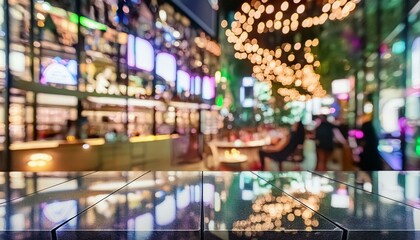 Empty black marble counter top with colorful, blurred nightclub bokeh lights in the background.