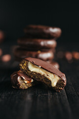 A dessert made of chocolate, dried fruits and coconut cream at dark background