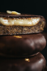A dessert made of chocolate, dried fruits and coconut cream at dark background