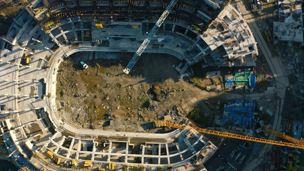 Vertical top view of construction of circular building. Stock footage. Construction site of...