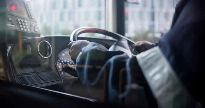 Hands, bus and driver of public transportation as city service for passengers downtown, metro or journey. Person, steering wheel and vehicle for morning commute in Boston or traveling, traffic or job