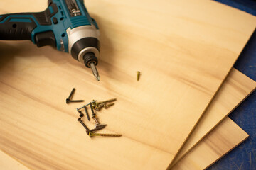 SCREWDRIVER AND WOODEN BOARD