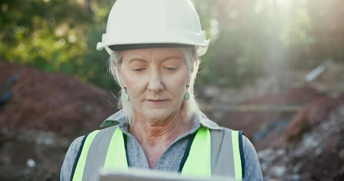 Helmet, tablet and mature woman in site, construction and contractor in property, outdoor and walkie talkie. Information, architect and person with update in maintenance, inspection and transceiver