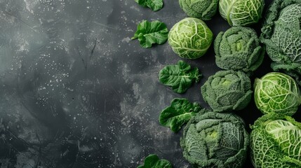  A group of green cabbages with leaves against a dark backdrop Space available for text or insertion of an adjacent image