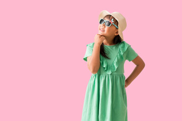 Happy smiling asian little girl were hat and sunglasses posing, Fashion summer holiday concept, Full body isolated on pink background