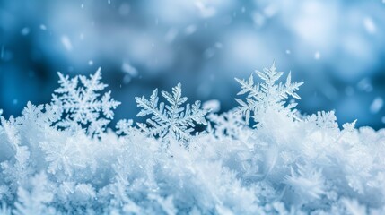  A tight shot of a solitary snowflake against a blue backdrop, subtly overlaid with hazy images of snowflakes above and below