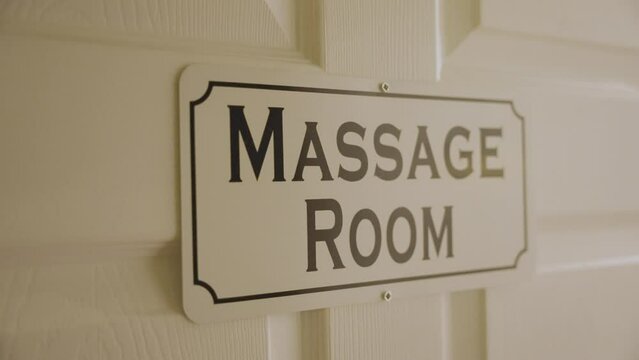 The door of the room at the massage center is labeled "Massage Room."