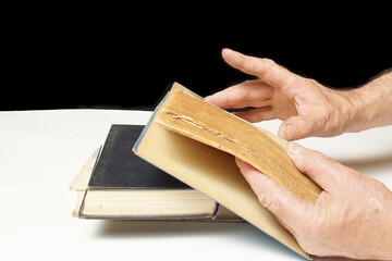 Male hands turning pages, book