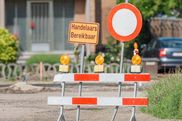 Road repair work with accessibility of retail outlets. Inscription in Dutch Handelaren beschikbaar...