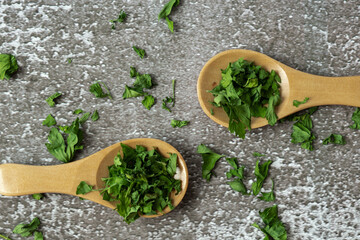 Fresh dried greenery parsley in wooden spoon adaptogens ingredient. Herbal medicine healthy eating....