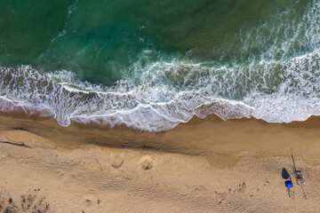 Aerial view of secluded beach with a beach umbrella