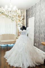 White wedding dress on a black dummy before the bride puts it on