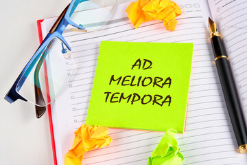 Ad meliora tempora it means in Latin may we meet in better times on a light green sticker on a...
