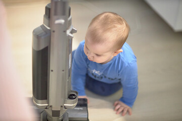 Baby Playing With Vacuum Cleaner in Room