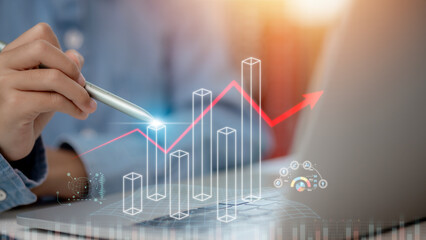 Businessman planning digital stock market analysis strategy showing positive technology chart...