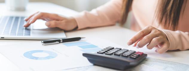 Deduction planning, debt asian young woman  hand using laptop computer, calculator calculating...