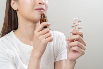 Aromatherapy, pretty asian young woman face expression enjoying smell fragrance of herbal from...