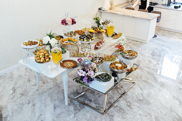 A wide variety of snacks on the table for guests. Shrimp, boiled pork, various types of meat and other products