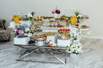 A wide variety of snacks on the table for guests. Shrimp, boiled pork, various types of meat and other products