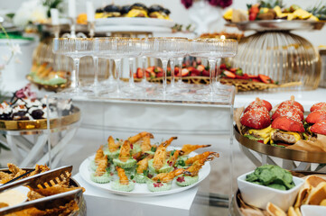 A wide variety of snacks on the table for guests. Shrimp, boiled pork, various types of meat and other products