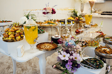 A wide variety of snacks on the table for guests. Shrimp, boiled pork, various types of meat and other products