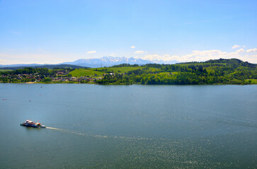 Boat floating on water near mountains and trees