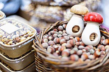 Vibrant marketplace scene featuring basket of fresh hazelnuts with charming mushroom-shaped...