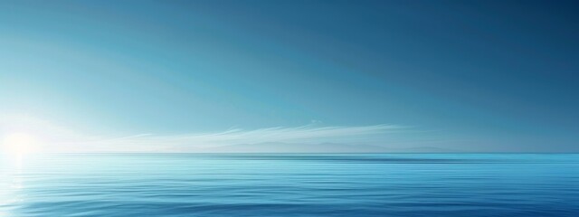 Fototapeta premium A minimalist background featuring a gradient of blue shades, evoking a calm ocean or sky.