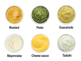Set of different sauces in bowls and names isolated on white, top view