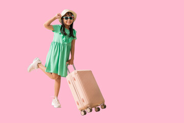 Happy smiling asian little girl were hat and sunglasses posing looking with suitcase, Travel fashion summer holiday concept, Full body isolated on pink background