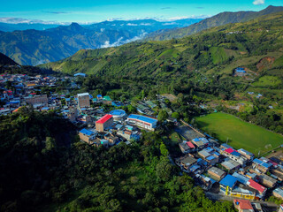 a scenic aerial view over small town surrounded by the mountains