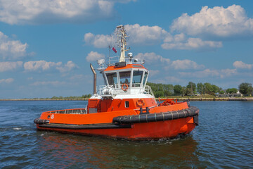 Fototapeta premium Port of Gdansk, Poland, large tanker PEARY SPIRIT enters the port, port tug VEGA sails to assist