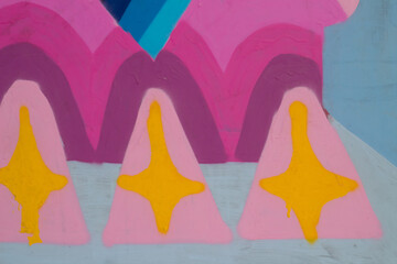 Close up of a geometric mural paint, wall textured background, small part of a big colorful street art graffiti on wall.