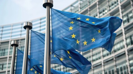 European Parliament Building in Brussels with EU flags waving in the foreground