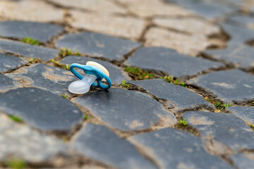 a lost baby pacifier on the street