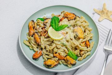 Plant based pasta with mussels, pesto and parmesan cheese. Ready to eat healthy food, served portion