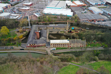 Aerial photo of the village of Armley in the city of Leeds in the UK showing the historic Leeds Industrial Museum at Armley Mills at the side of the canal in the winter time