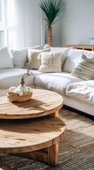 Round wood coffee table against white sofa. Scandinavian home interior design of modern living room.