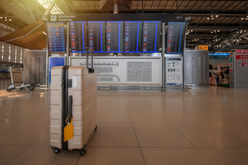 Golden suitcases sit prominently in front of the digital departure board at Suvarnabhumi...