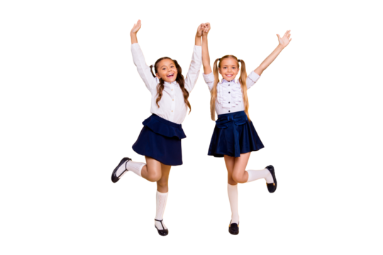Full length, legs, body, size portrait of cheerful, cute, nice, lovely, sweet small girls in skirts raise their hands up and look at camera bend leg in the knee isolated on shine yellow background